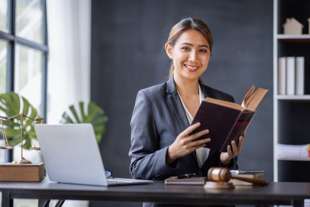Attractive lawyer in office Business woman and lawyers discussing contract papers with brass scale o