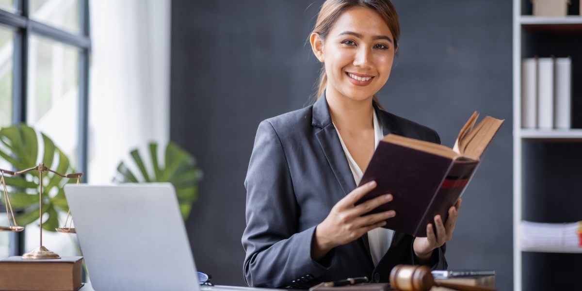Attractive lawyer in office Business woman and lawyers discussing contract papers with brass scale o